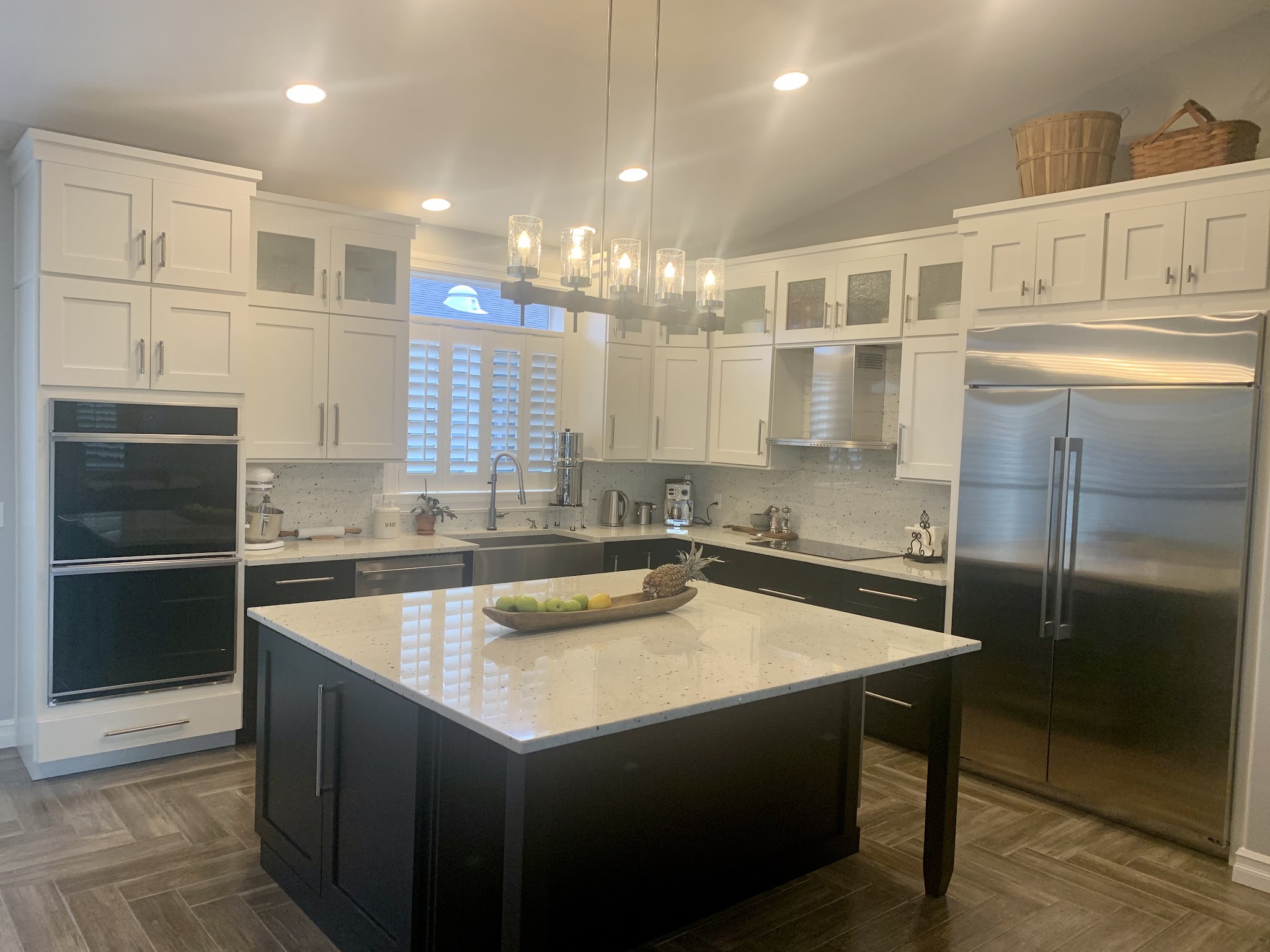 Full kitchen remodel by By the Sea Home & Gardens with white shaker cabinetry, quartz counters and a stainless double wall oven, Bandon, Oregon