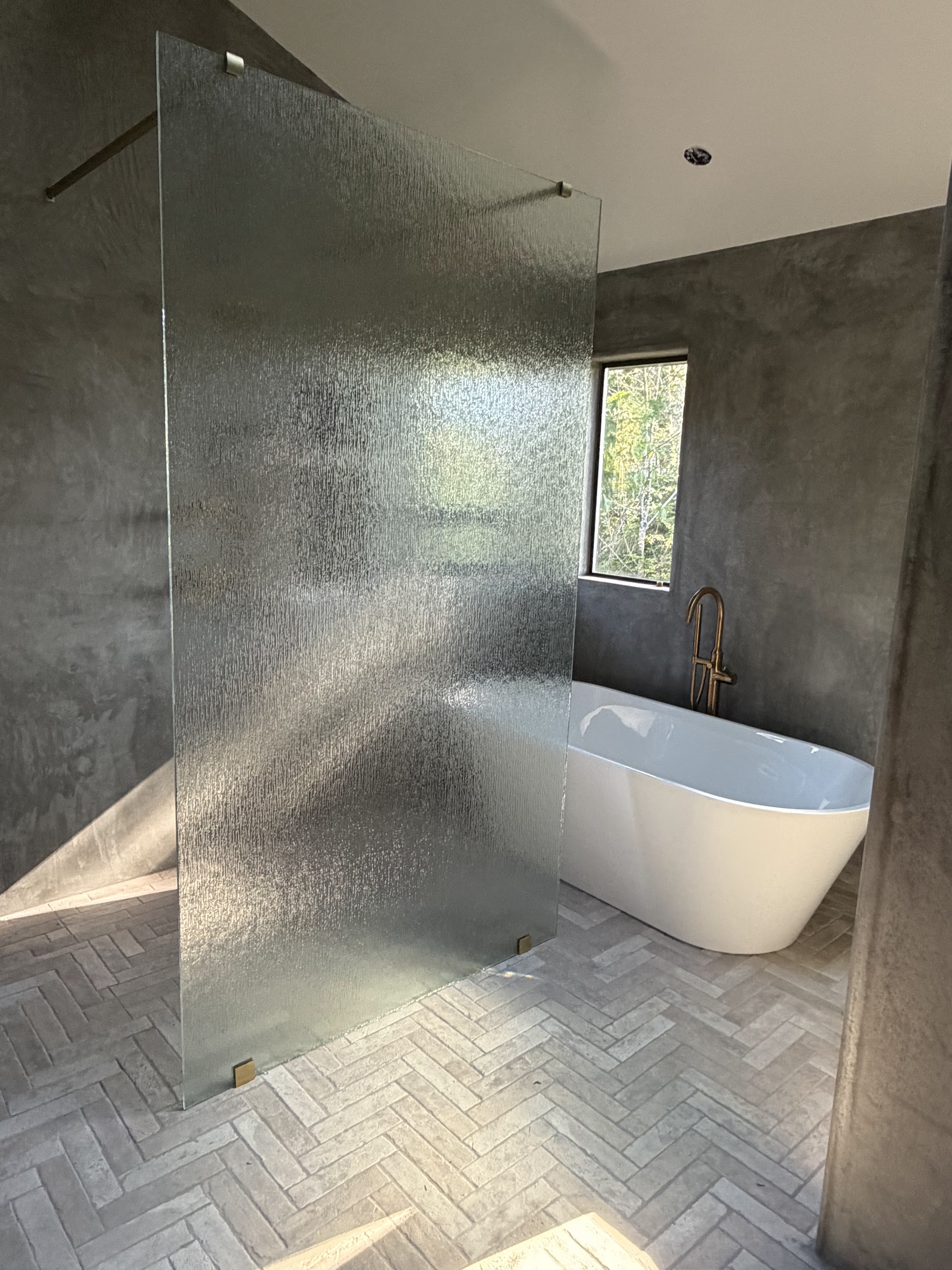 Bathroom remodel by By the Sea Home & Gardens with a frameless glass walk-in shower, brass fixtures and a freestanding soaking tub
